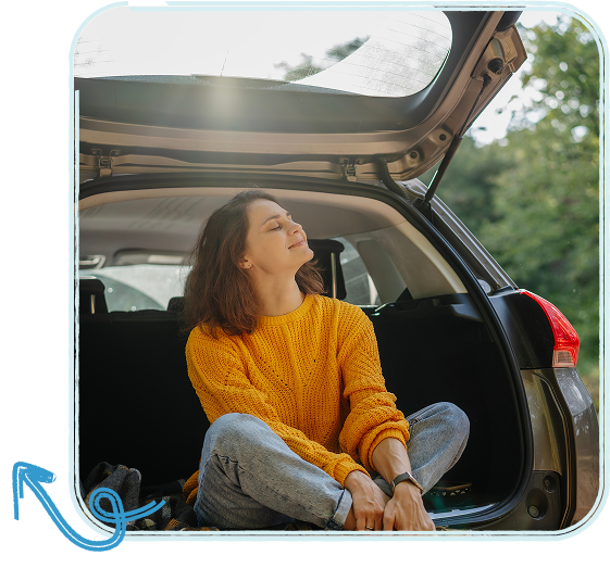 woman sitting in trunk of car